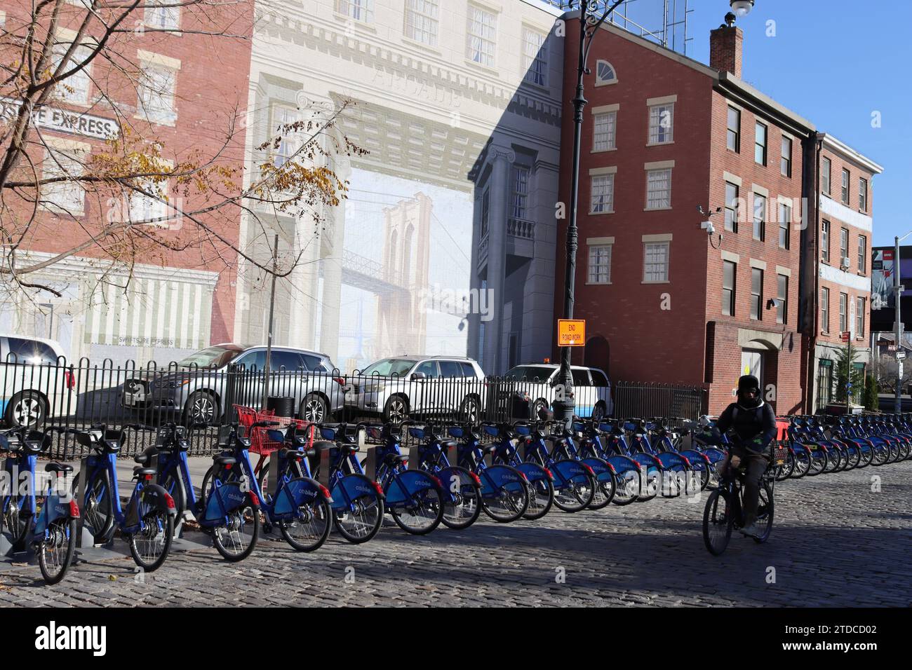 Citibike station by of mural of Brooklyn Bridge on Con Edison Seaport Substation on Peck Slip at South Street Seaport in lower Manhattan, New York Stock Photo