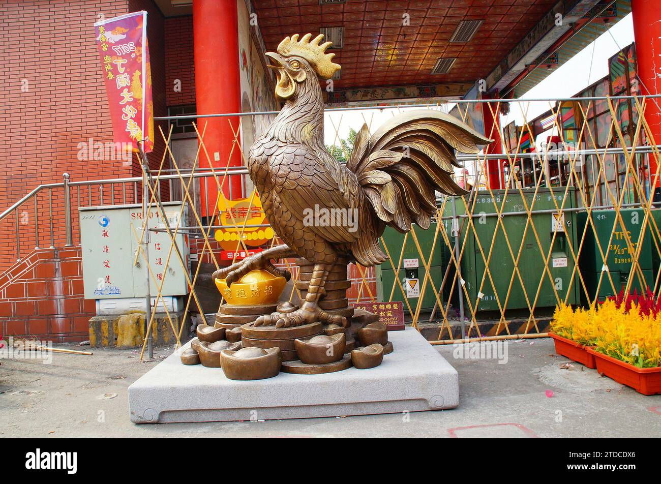 A golden rooster statue in front of the temple Stock Photo Alamy