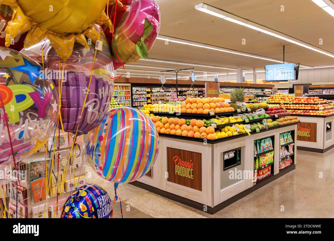 Balloons and produce and section inside a supermarket in San Diego, California Stock Photo