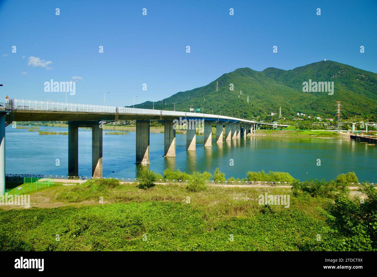 Hanam City, South Korea - October 1, 2023: Paldang Bridge spans the Han River under blue skies, Yebongsan Mountain towering in the distance, entering Stock Photo