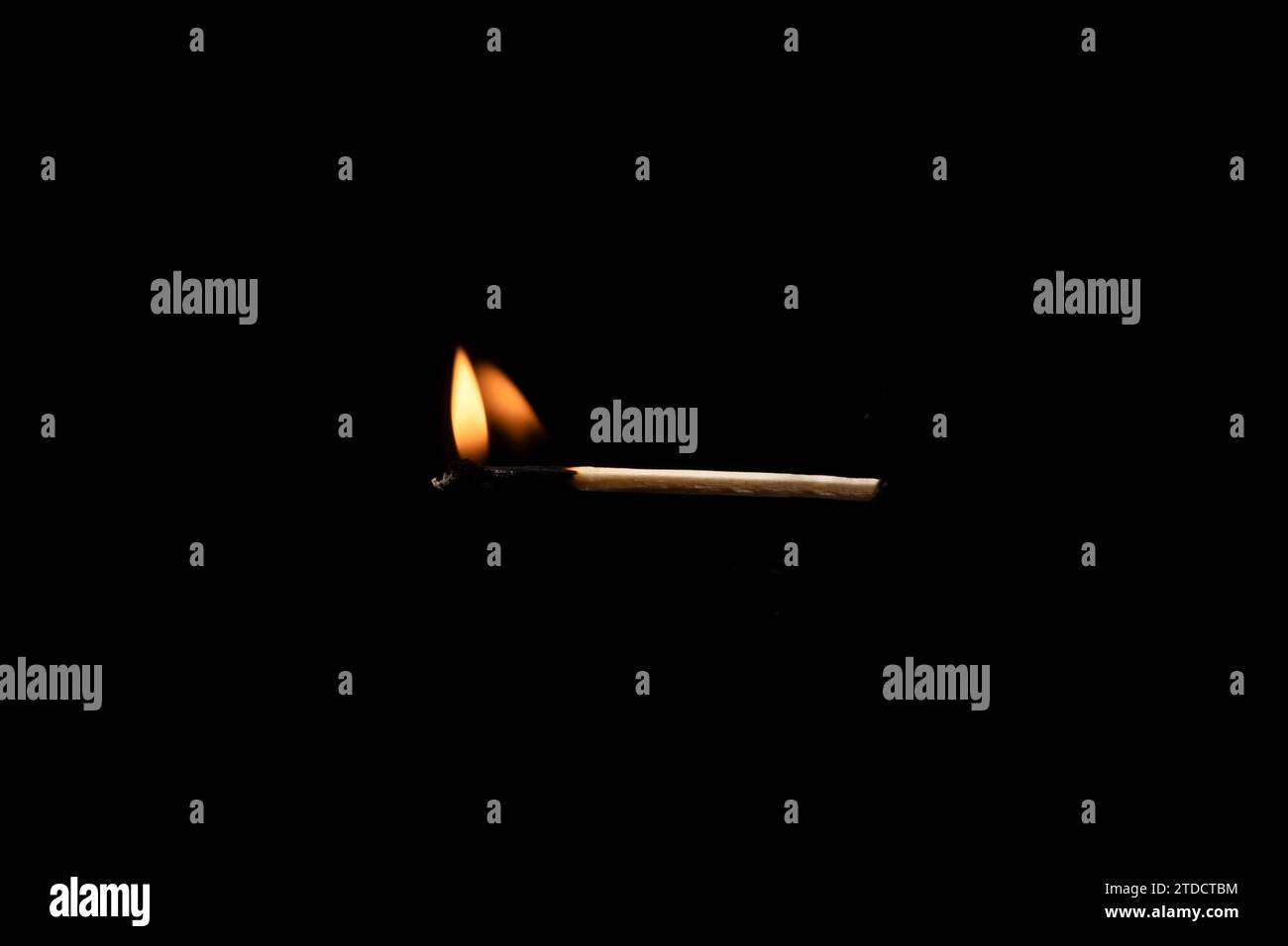 Lit and falling match on a black background. Stock Photo