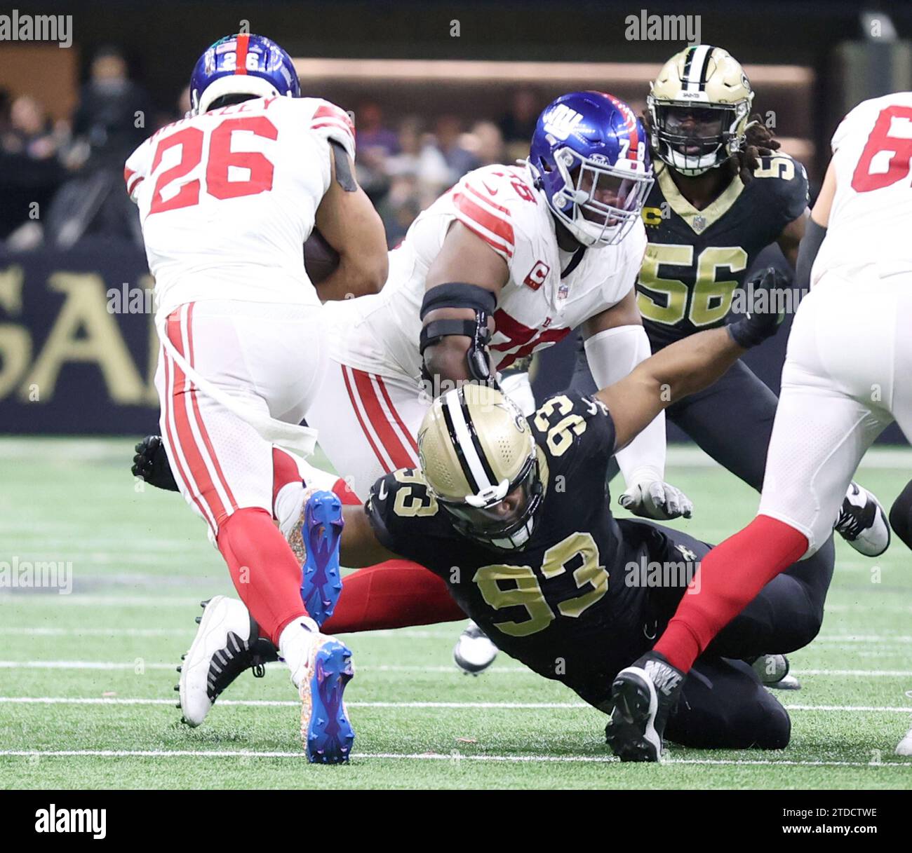 New Orleans, USA. 17th Dec, 2023. New Orleans Saints defensive tackle Nathan Shepherd (93) tries to trip up New York Giants running back Saquon Barkley (26) during a National Football League game at the Caesars Superdome in New Orleans, Louisiana on Sunday, December 17, 2023. (Photo by Peter G. Forest/Sipa USA) Credit: Sipa USA/Alamy Live News Stock Photo