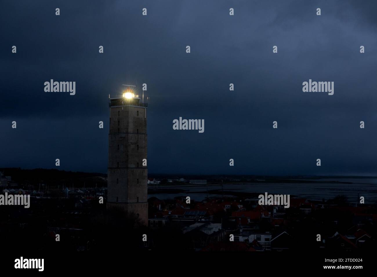 Lighthouse Brandaris on the Dutch island Terschelling by night under a cloudy sky Stock Photo
