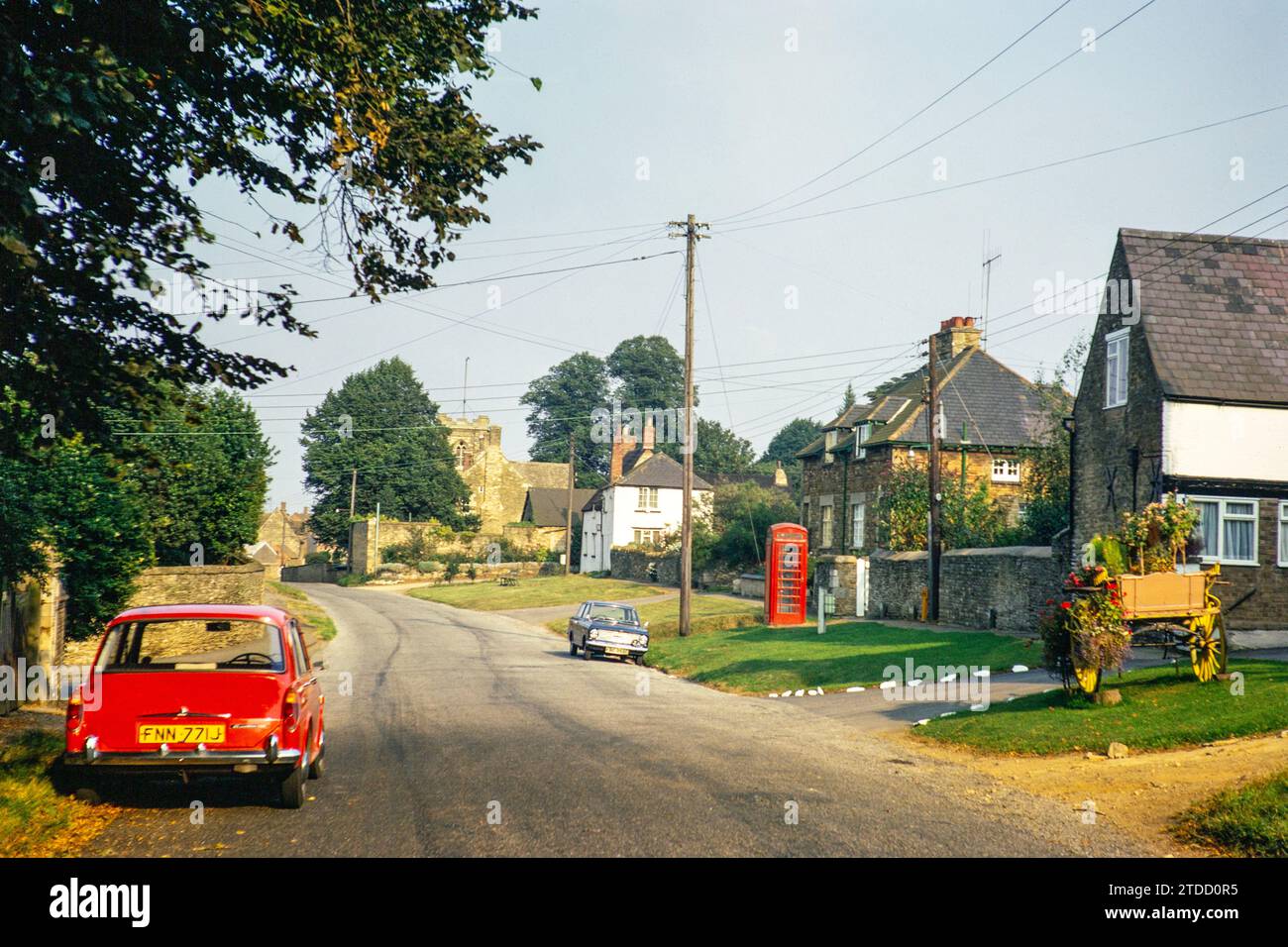 Village street, Wing, Rutland, England, UK August 1972 Red Austin Morris 1100 Mk 2 car Stock Photo