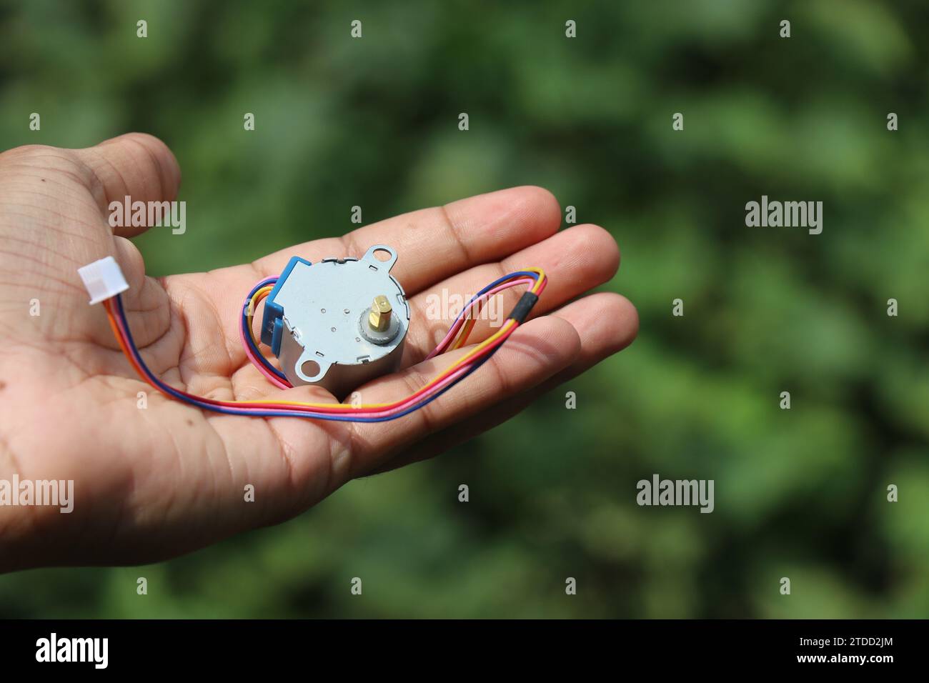 Stepper motor used in hobby electronic projects held in hand Stock