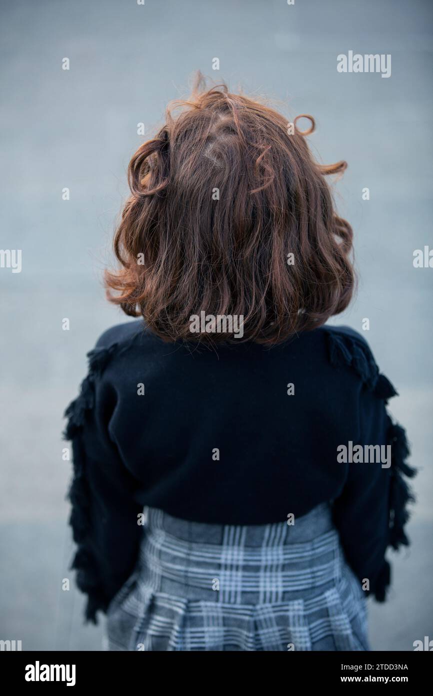 Rear view of little girl standing outdoors Stock Photo - Alamy
