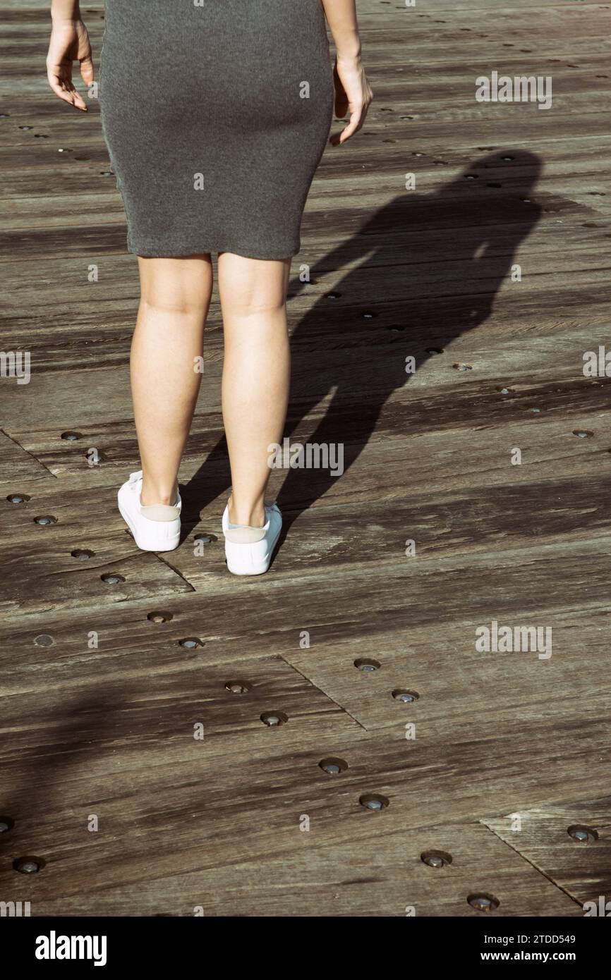 Rear view of woman standing outdoors Stock Photo - Alamy
