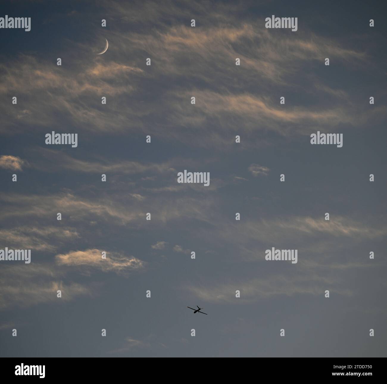 High resolution image of an Israeli air-force single isolated drone in the distance with partly cloudy background Stock Photo