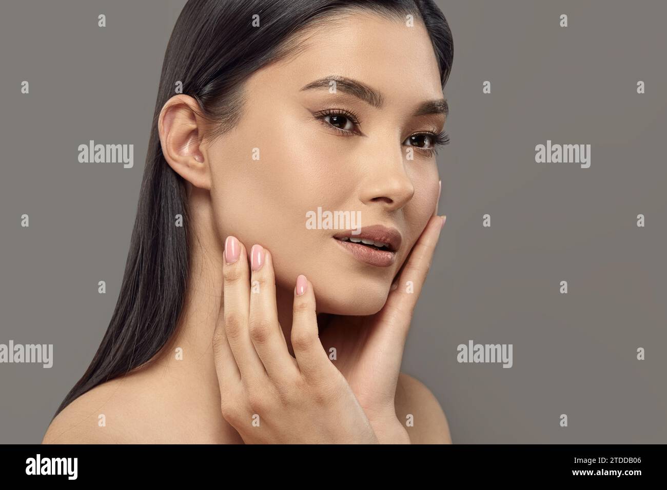Beauty woman touching her face with hands enjoying soft smooth skin ...