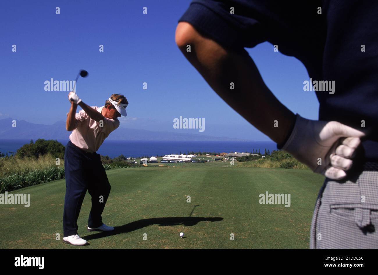 A man striking the ball on the golf course, Hawaii, USA. Stock Photo