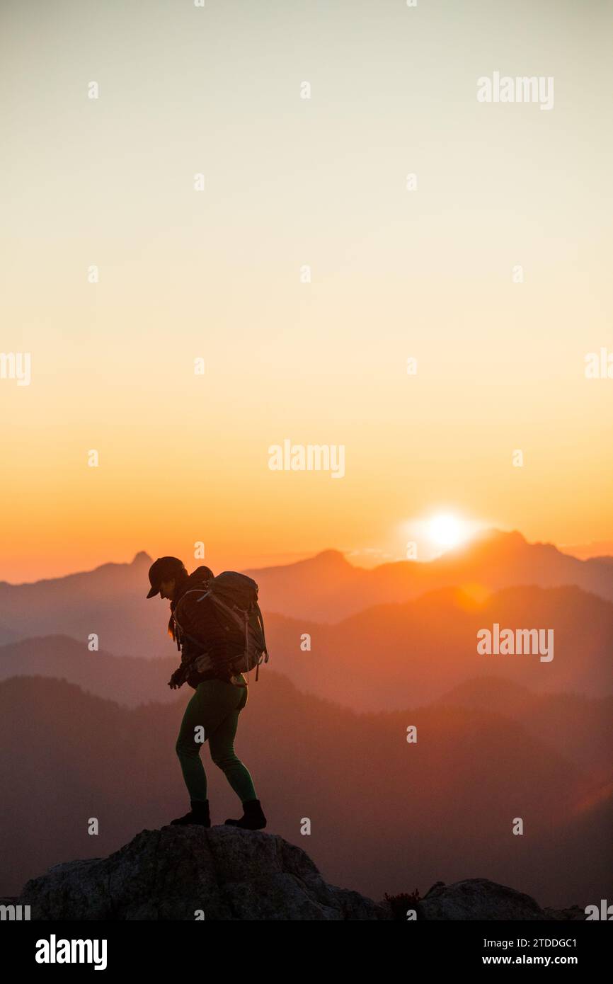 Fit young female hiker on mountain summit Stock Photo