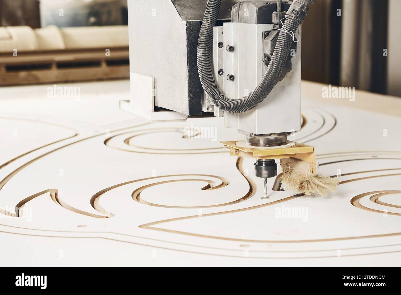 Numerically controlled woodworking machine cuts rounded complex lines on the canvas. Computer numerical control. CNC. Stock Photo