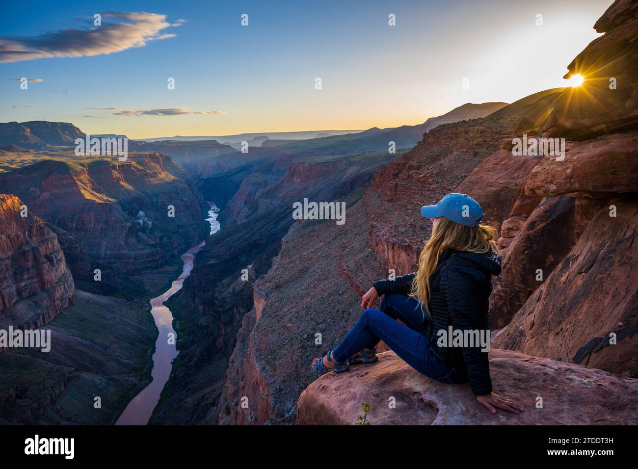 Woman Looking out over the Grand Canyon from Toroweap Stock Photo
