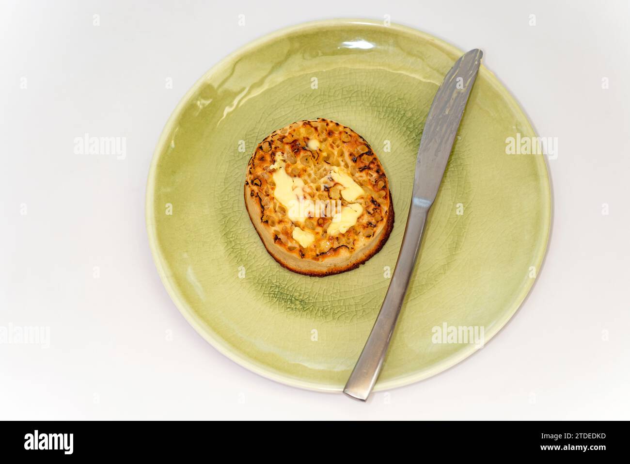 Toasted buttered crumpet Stock Photo