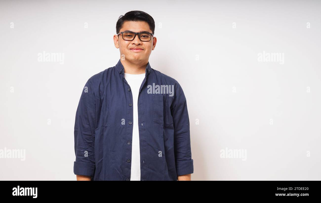 Smiling young Asian man wearing casual shirt on white background. studio shot Stock Photo