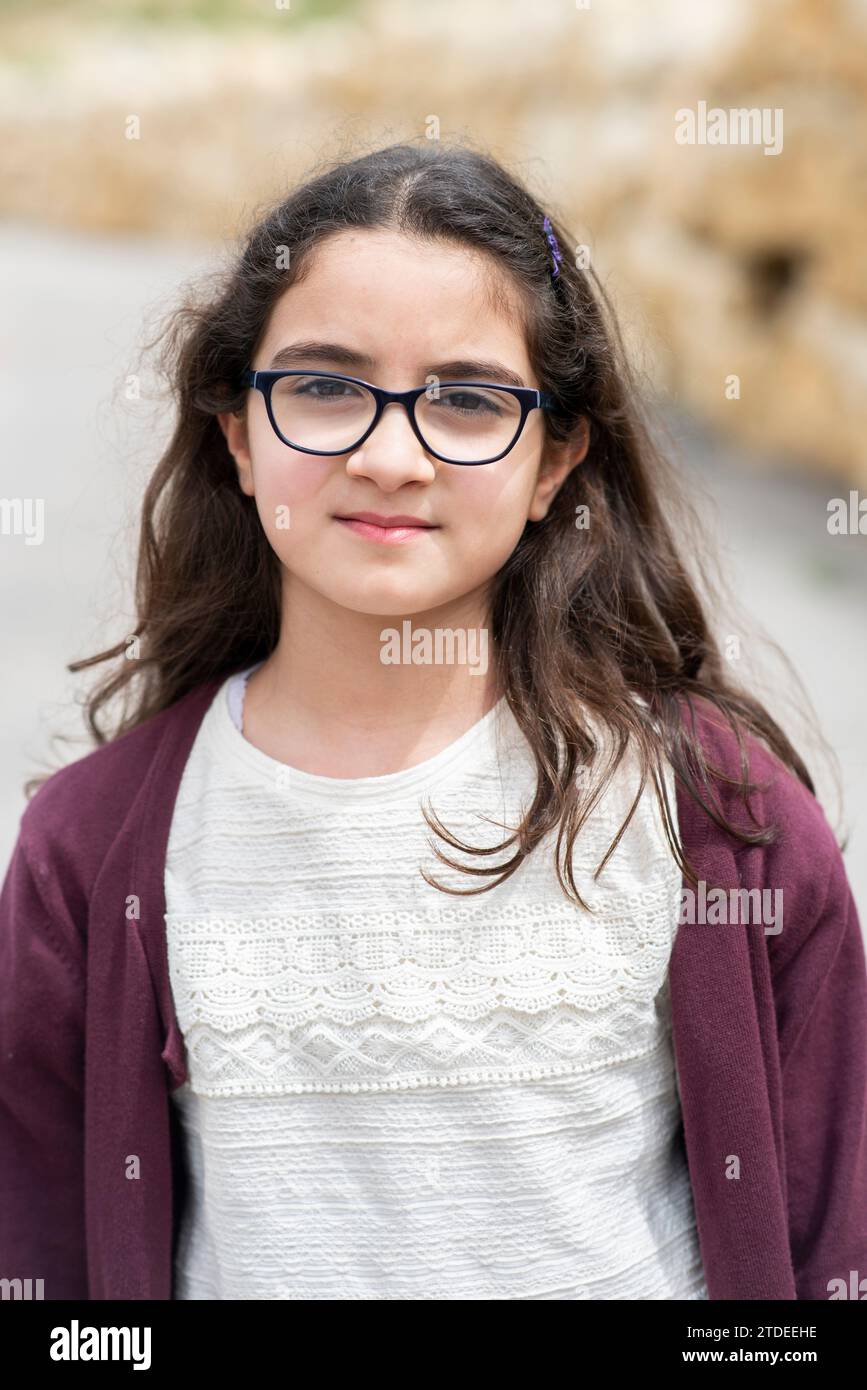 Beautiful girl wearing eyeglasses looking at camera outdoors Stock Photo