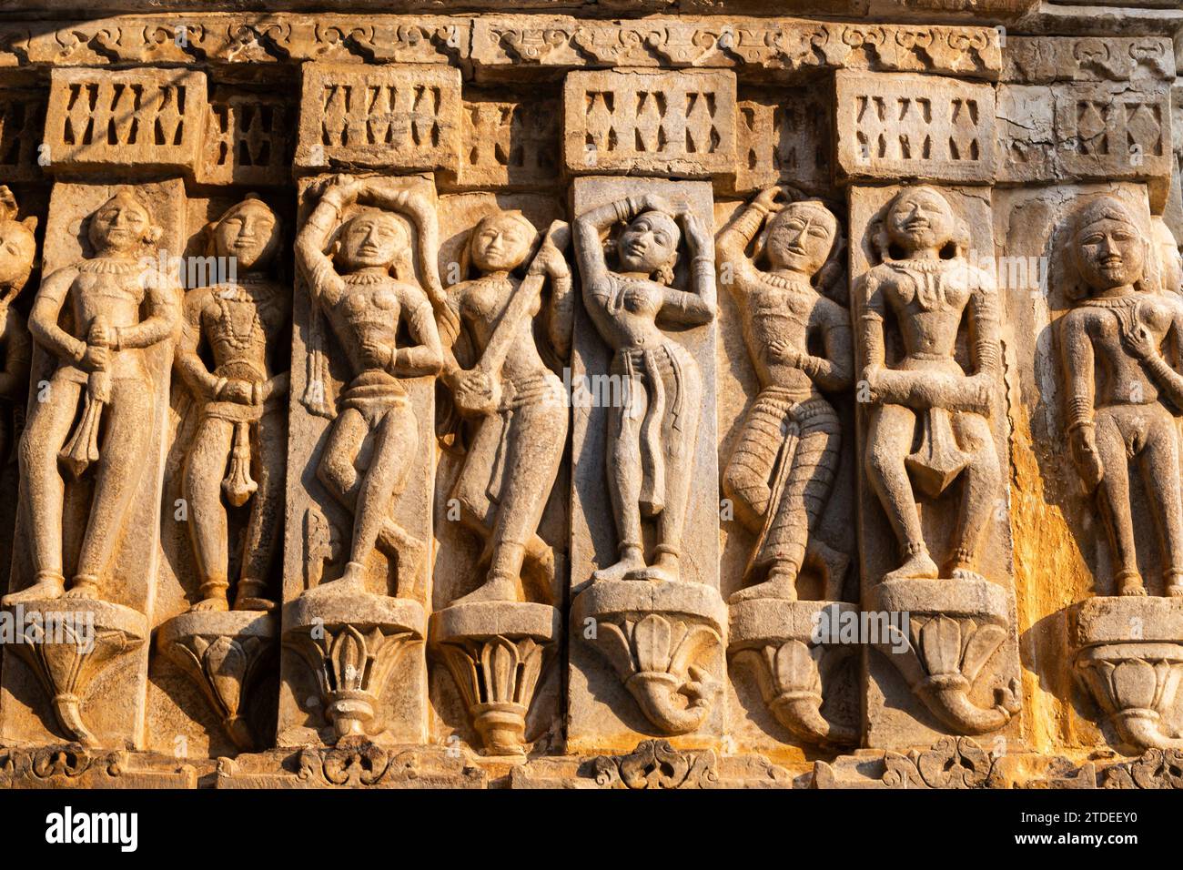 Sculptures of musicians and dancers on hindu holy temple wall at golden hour image is taken at Jagdish Temple udaipur rajasthan india. Stock Photo