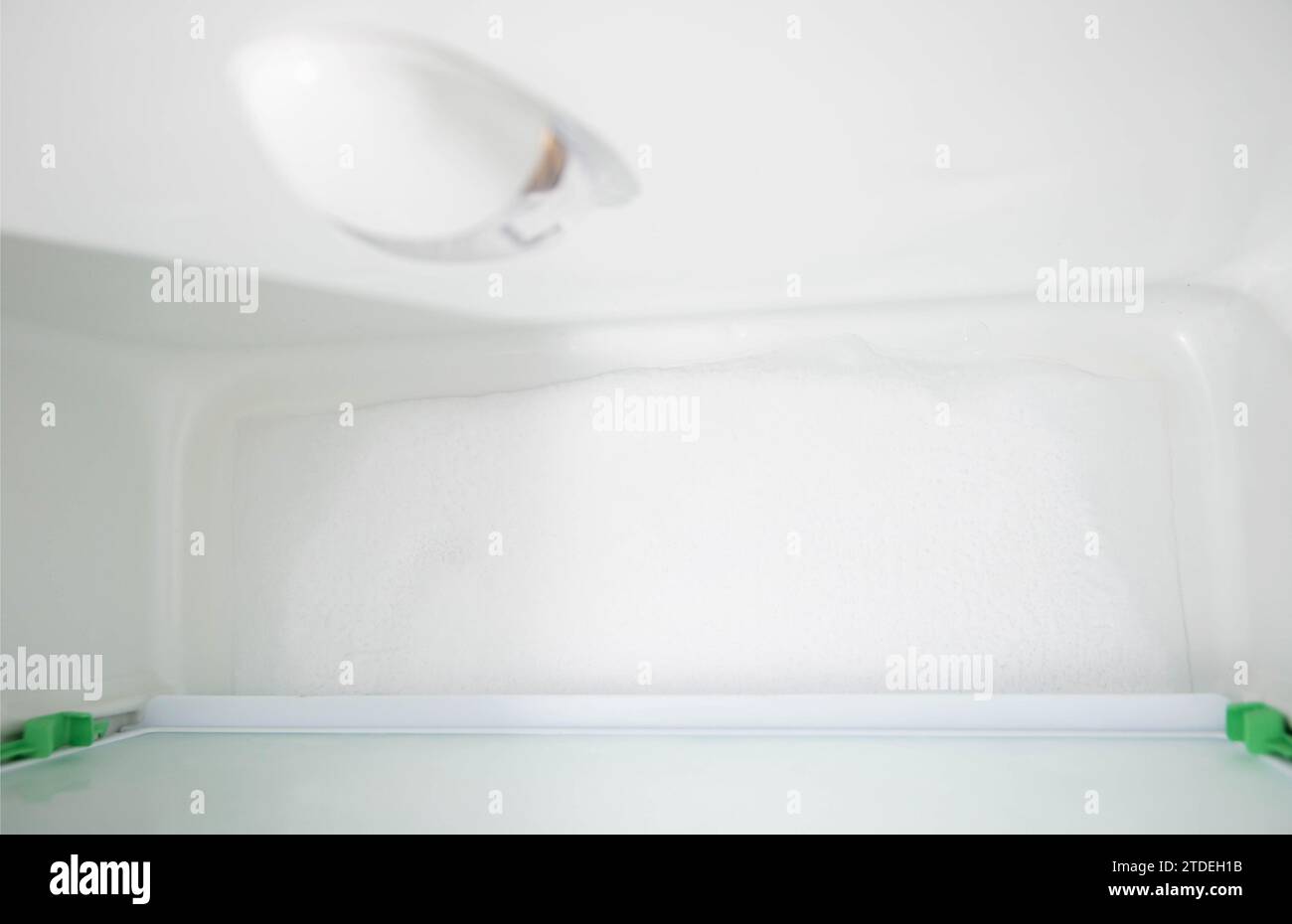 Ice and snow build up on the back wall of the refrigerator