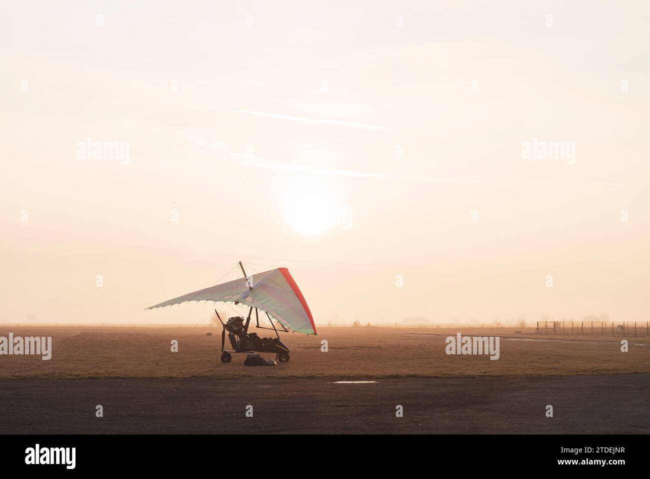 Motorized hang glider trike on the runway in the early morning. Moody aviation photo Stock Photo