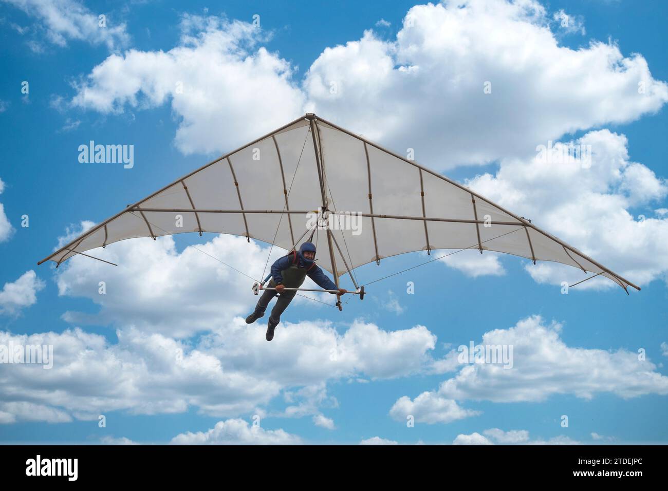 Old vintage hang glider paraglider kite in the sky with clouds. Learning to fly. Dream of flying. Modern Icarus. Stock Photo