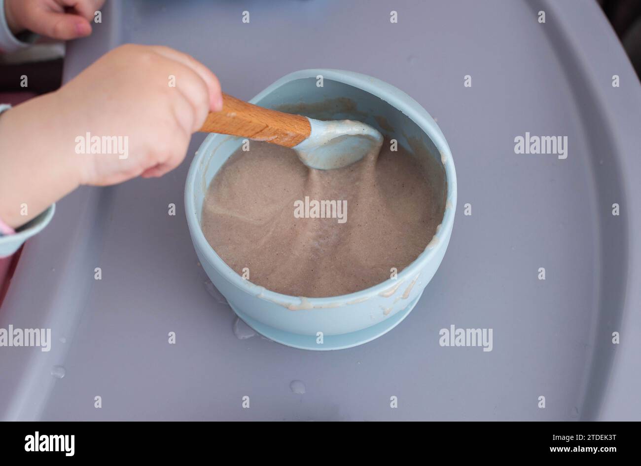Dairyfree buckwheat baby porridge in a plate on the table. Nutritious glutenfree porridge for