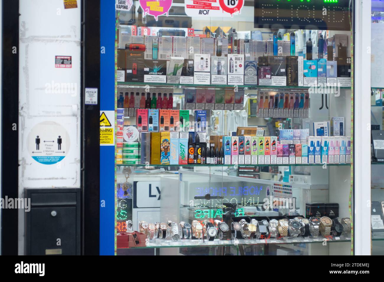 Slough, Berkshire, UK. 16th December, 2023. Vape advertising in a shop in Slough, Berkshire. The World Health Organisation has called for flavoured vapes to be banned worldwide. They have said  that 'urgent measures' are were needed to control e-cigarettes. There are many ex smokers who are now hooked on vaping. Credit: Maureen McLean/Alamy Stock Photo