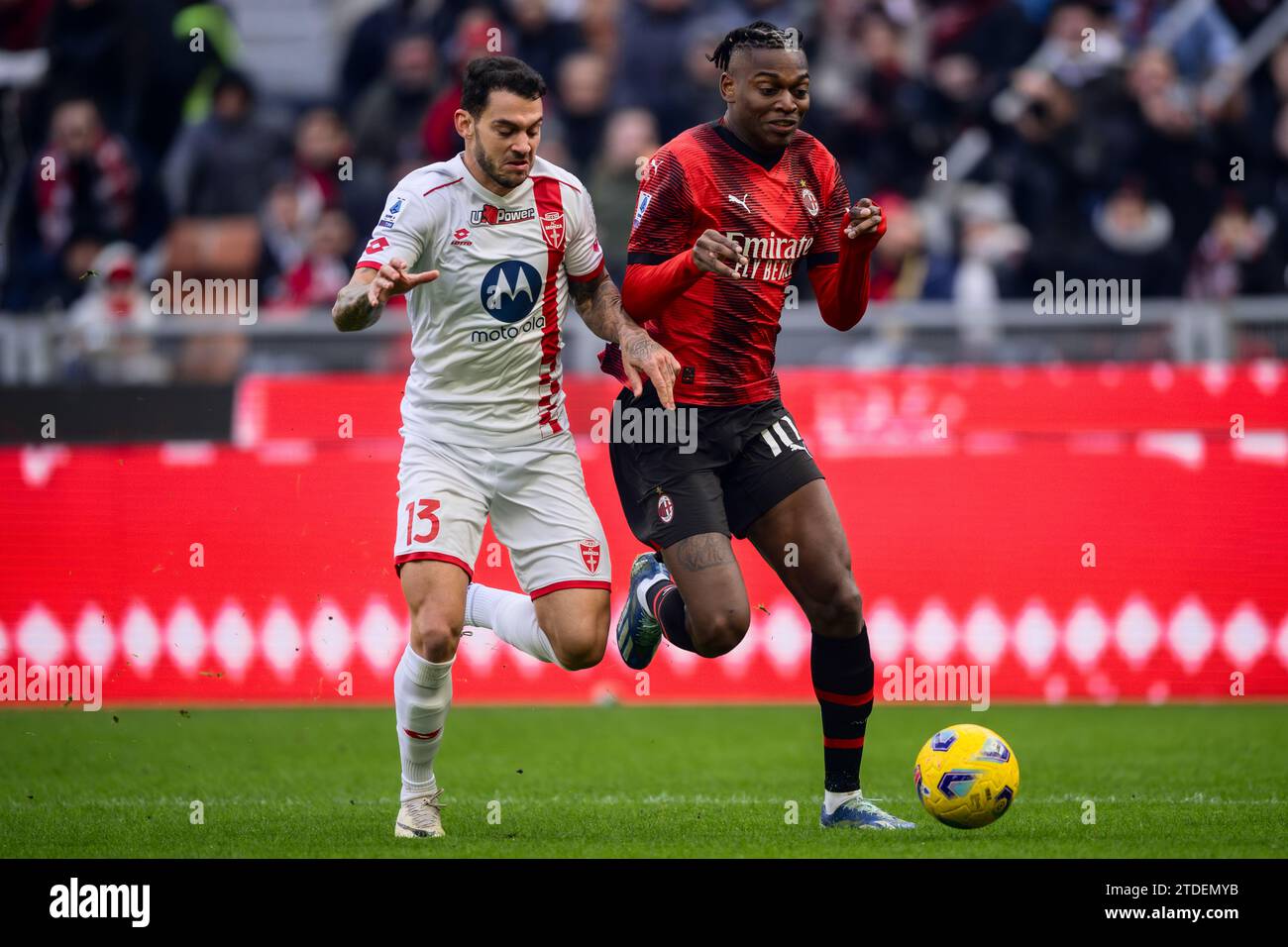 Milan, Italy. 18 December 2023. Rafael Leao of AC Milan competes for the ball with Pedro Pereira of AC Monza during the Serie A football match between AC Milan and AC Monza. Credit: Nicolò Campo/Alamy Live News Stock Photo