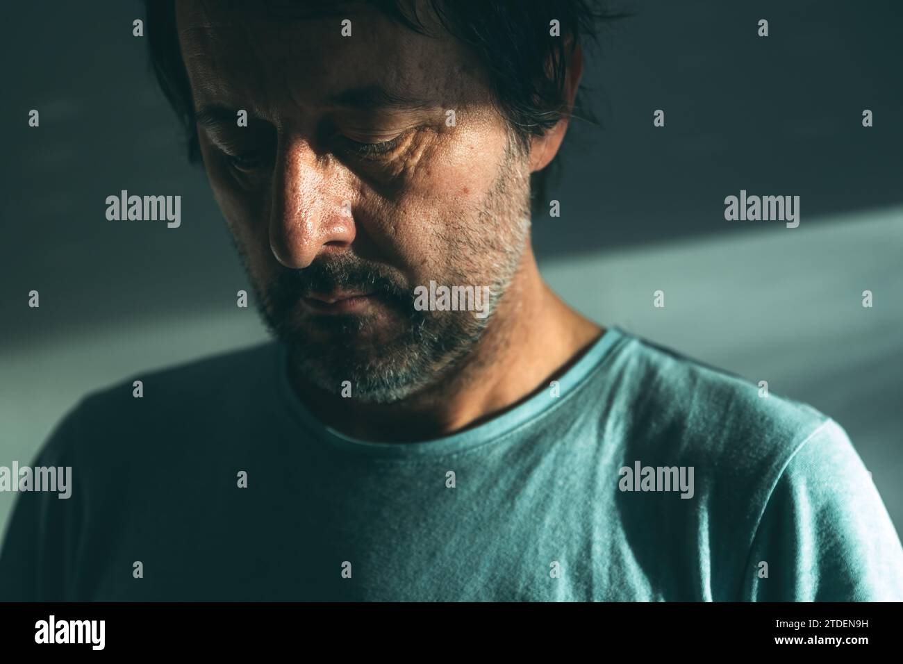 Midlife crisis of middle aged man. Closeup portrait of man in 40s in a depressed state of mind, sad and hopeless. Selective focus. Stock Photo