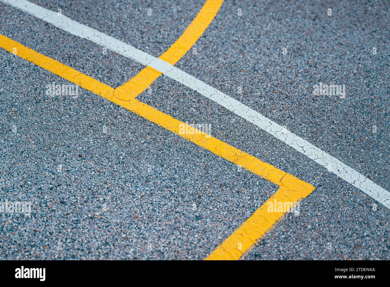 Outdoor basketball court lines and markings on concrete flooring