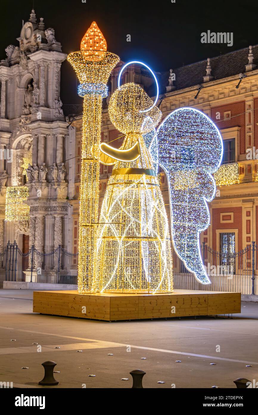 Christmas lights decoration in the shape of an angel holding a torch in from of The Palace of San Telmo, In Seville, Andalusia, Spain, at Christmas ti Stock Photo