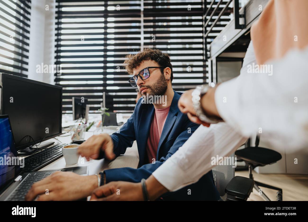 Working Cooperate A group of businesspeople working together in a corporate office ...