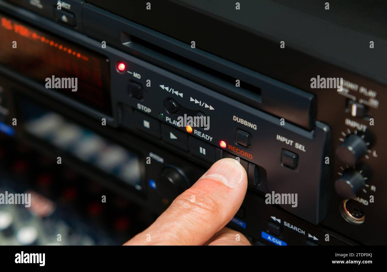 Finger pressing record button of professional minidisc player Stock