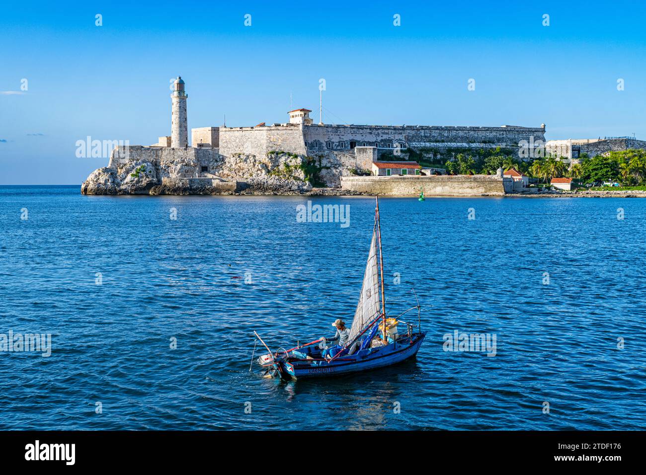 Little fishing boat in front of Fort of San Carlos of the Cabin (Fortaleza de San Carlos de la Cabana (Fort of St. Charles) Stock Photo