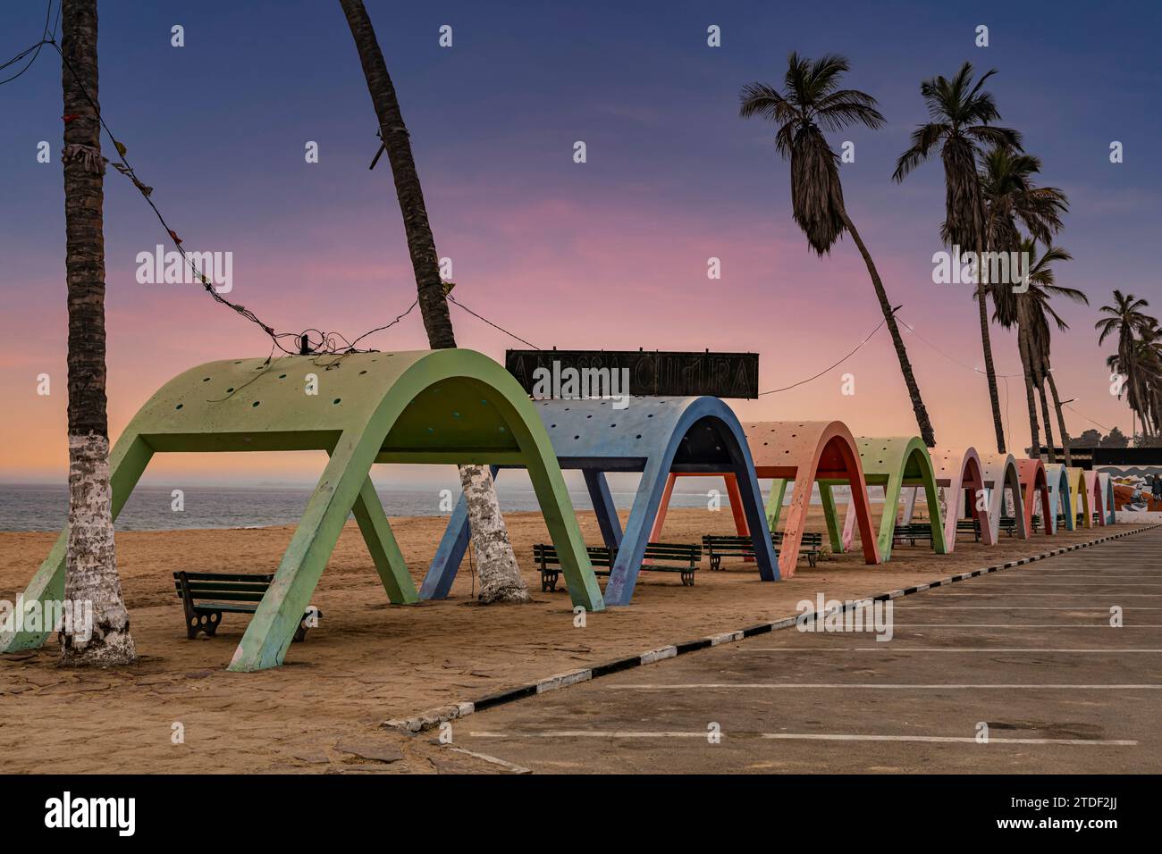 Blue hour over the beach with colonial concrete beach shades in the town of Namibe, Angola, Africa Stock Photo