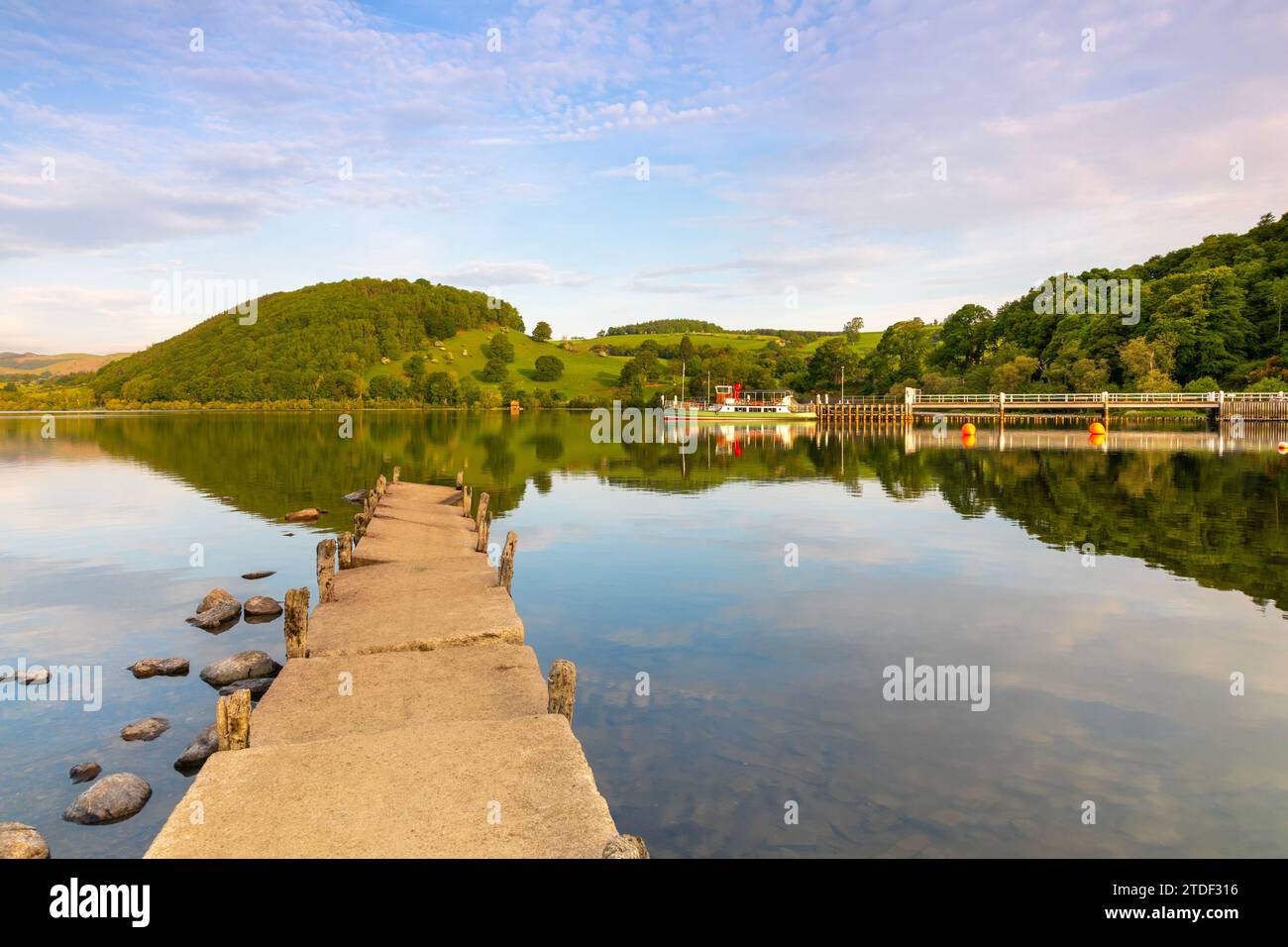 Wooden Pier and steamer boat in background, Ullswater, Lake District National Park, UNESCO World Heritage Site, Cumbria, England, United Kingdom Stock Photo