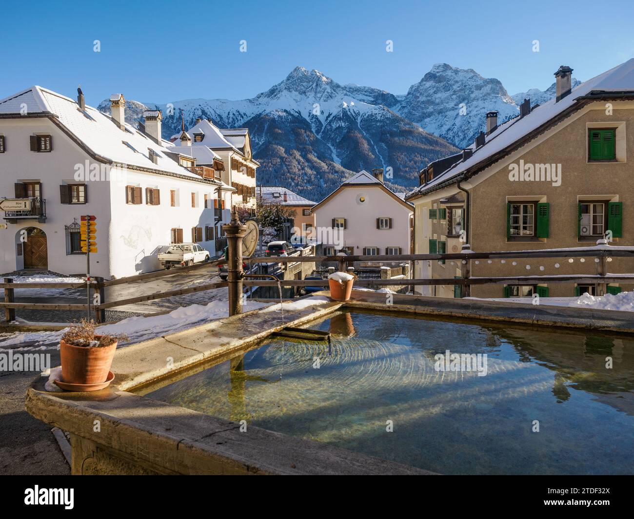 A plaza and fountain in the Alpine village of Sent in winter, Sent, Switzerland, Europe Stock Photo