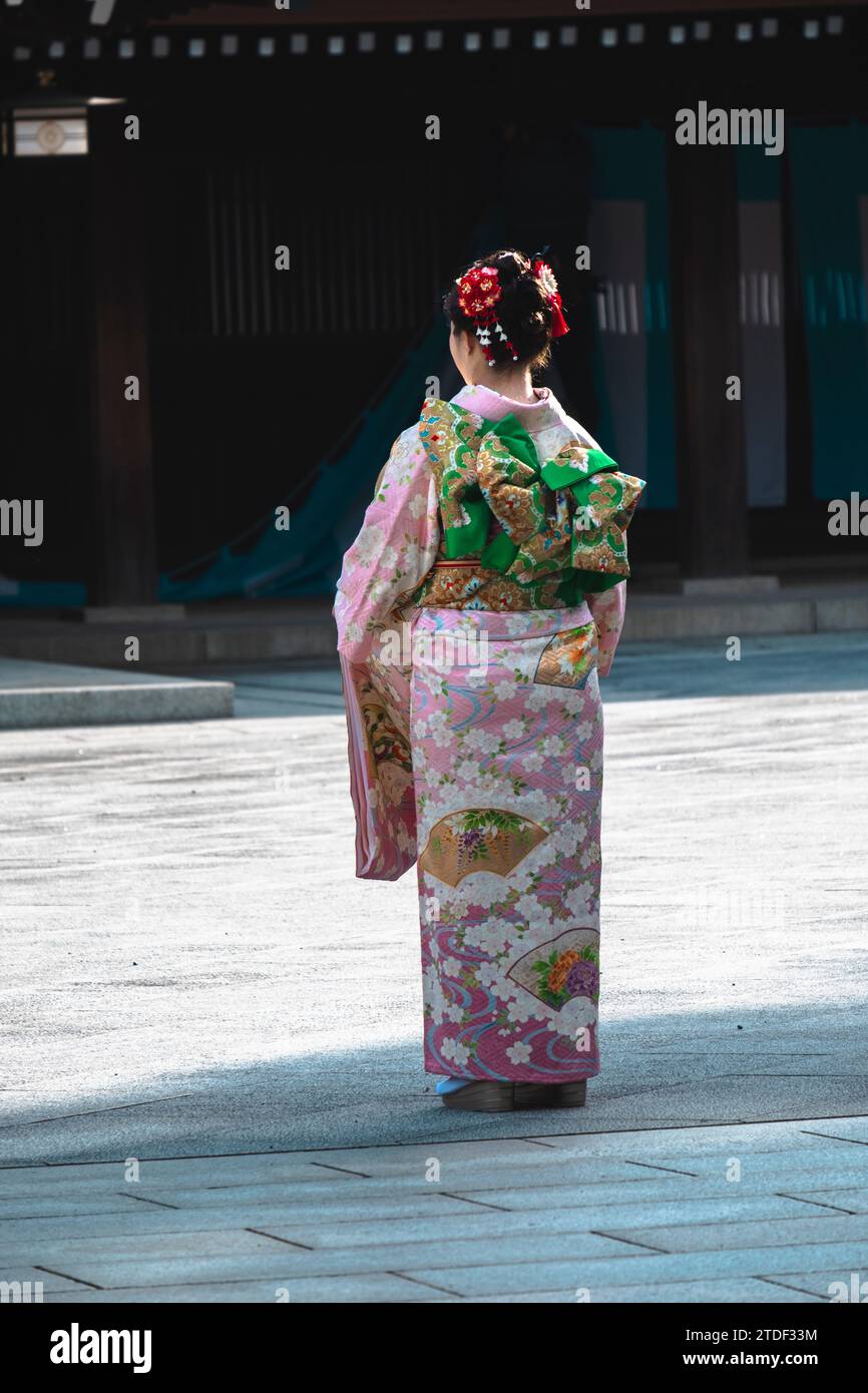 A girl seen from the back in traditional clothes in a Tokyo temple, Tokyo, Honshu, Japan, Asia Stock Photo