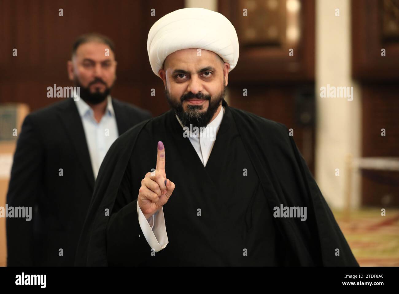 Baghdad, Iraq. 18th Dec, 2023. Head of Iraq's Asaib Ahl al-Haq Qais Khazali shows his ink-stained finger after voting in the first provincial council elections in a decade. Credit: Ameer Al-Mohammedawi/dpa/Alamy Live News Stock Photo
