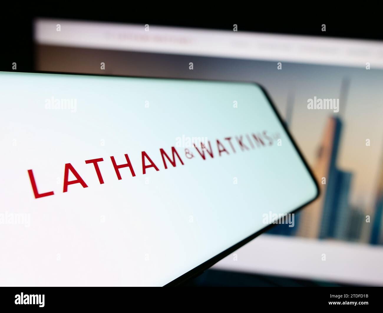 Smartphone with logo of American law firm Latham and Watkins LLP (LW) in front of business website. Focus on left of phone display. Stock Photo