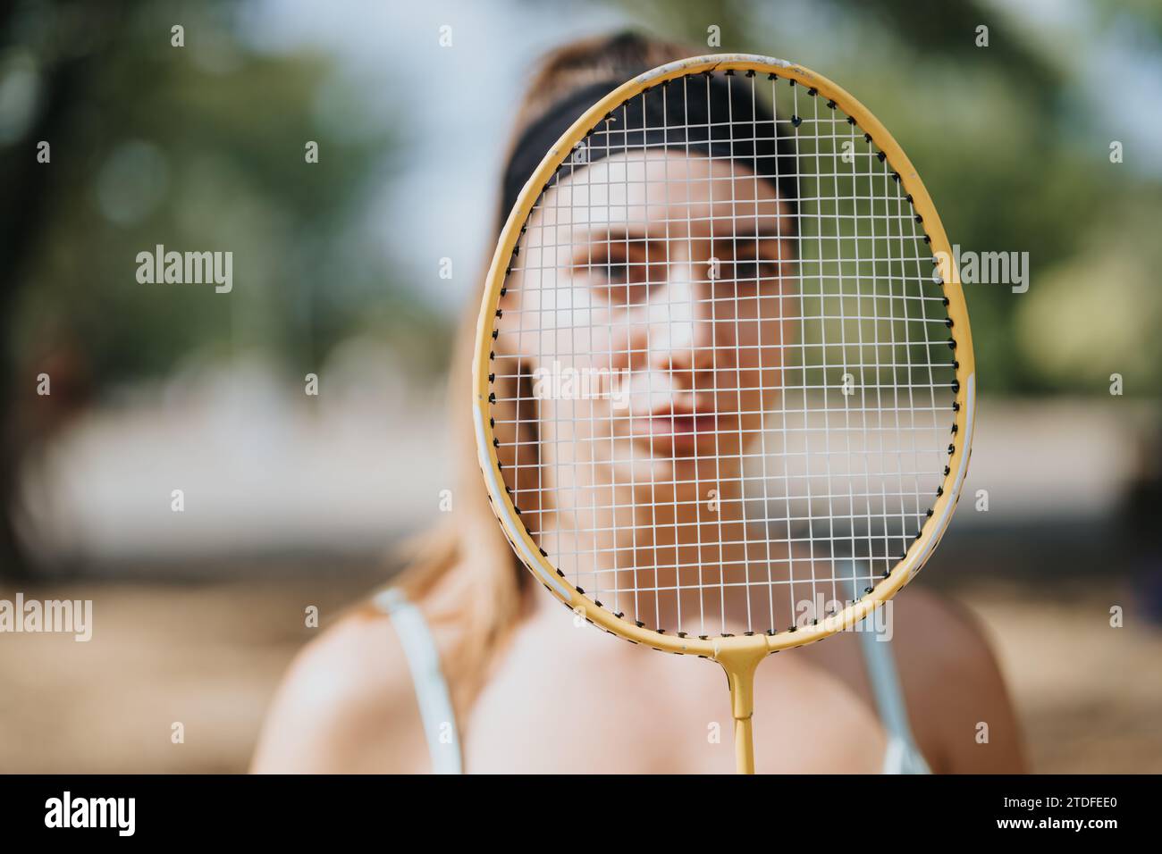 Professional, female, badminton player posing with racket for the