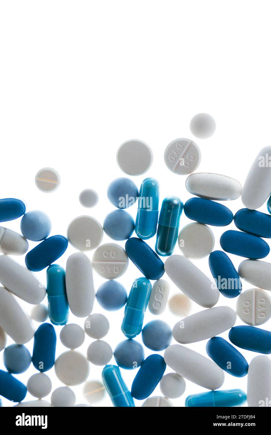 Blue and white pills and tablets against white background Stock Photo