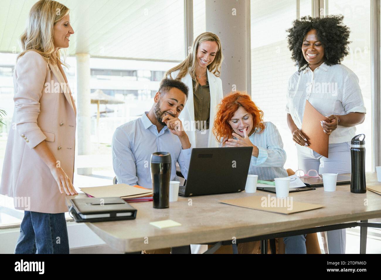 Diverse group of business people smiling while working together at the office. Business concept. Stock Photo