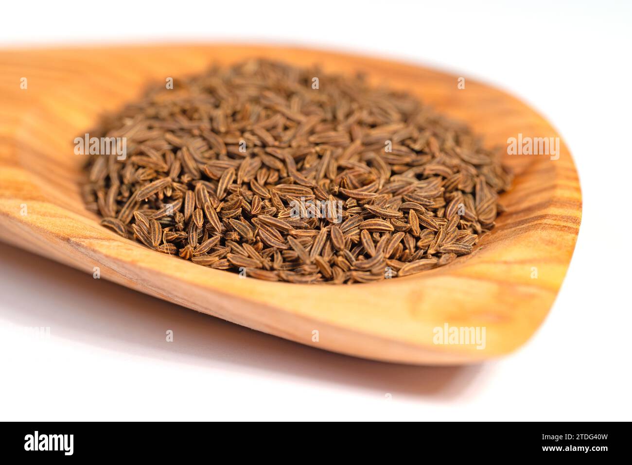 Cumin seeds on a wooden spoon Stock Photo