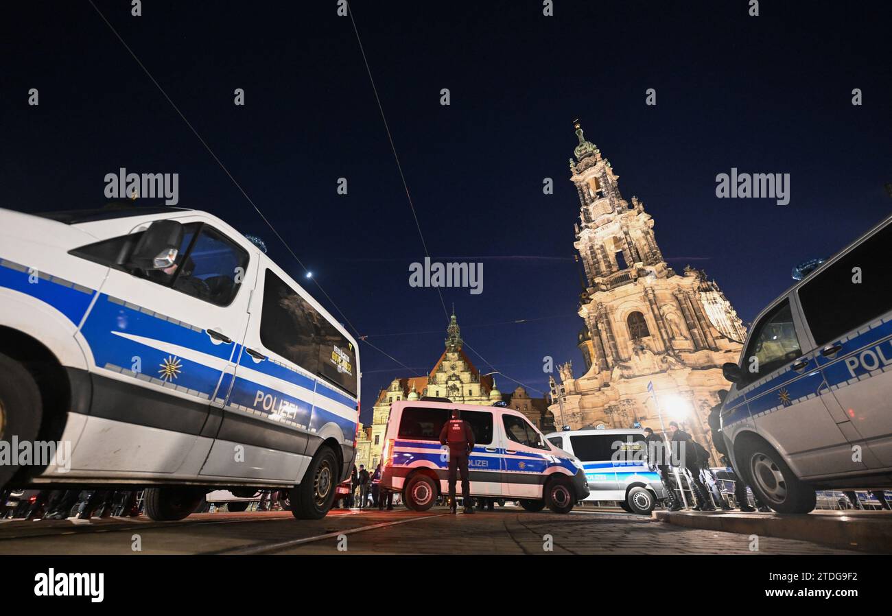 Dresden, Germany. 18th Dec, 2023. Police cars stand in front of the Hofkirche before the start of a counter-demonstration by the 'Herz statt Hetze' initiative against an announced demonstration by the right-wing extremist movement Pegida on the Augustusbrücke. Credit: Robert Michael/dpa/Alamy Live News Stock Photo