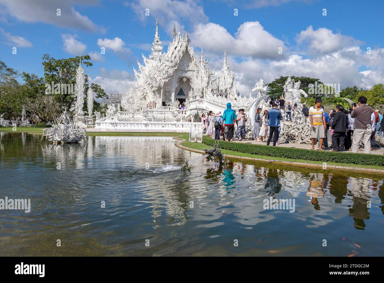CHIANG RAI, THAILAND - DECEMBER 16, 2018: A group of tourists at the Wat Rong Khun Buddhist Temple (White Temple). Chiang Rai, Thailand Stock Photo