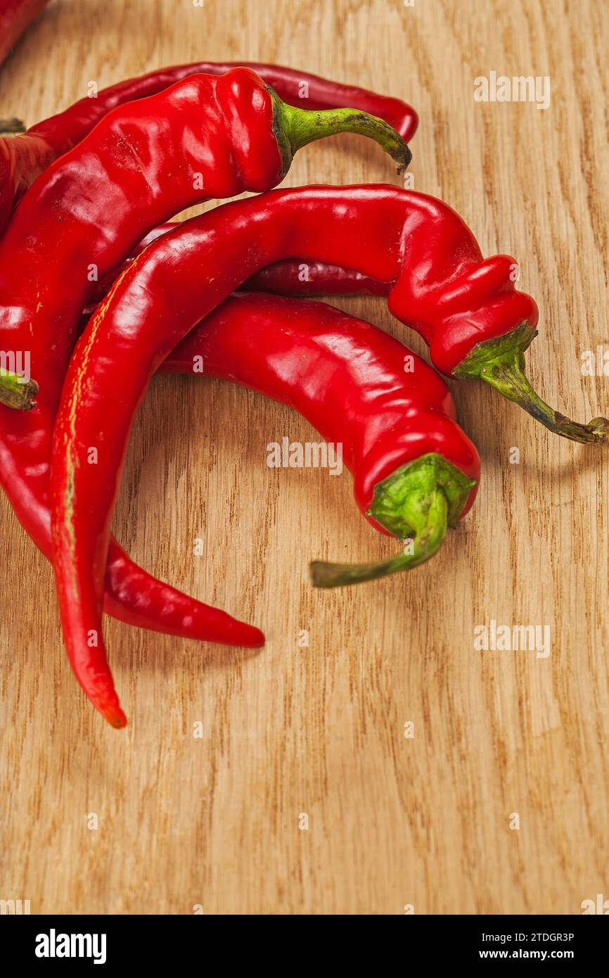 Red chilli peppers on wooden board Stock Photo - Alamy