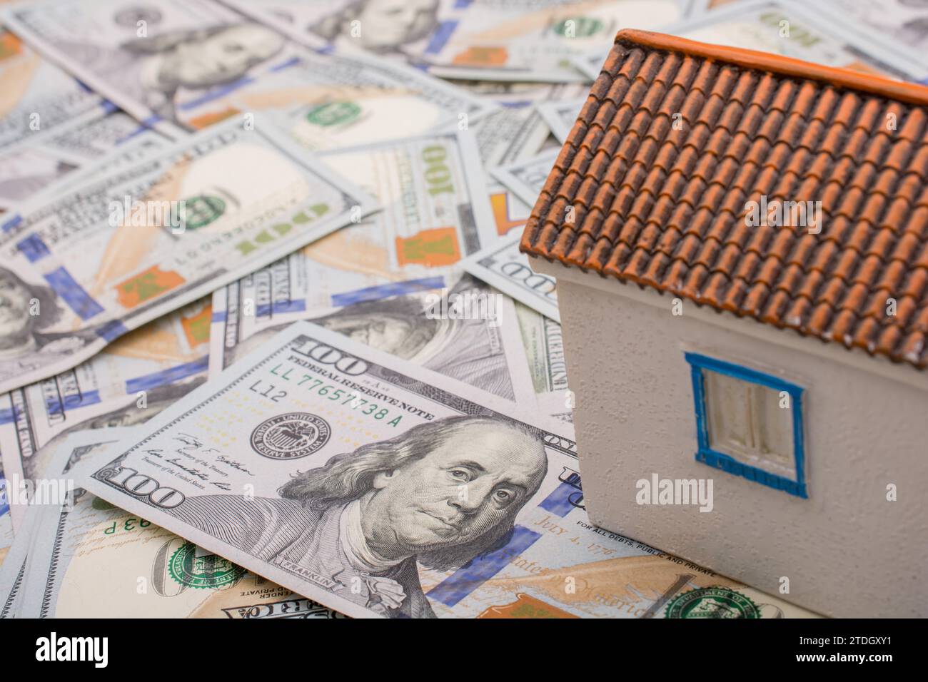 Model house is placed US dollar Banknotes on spread on the background Stock Photo