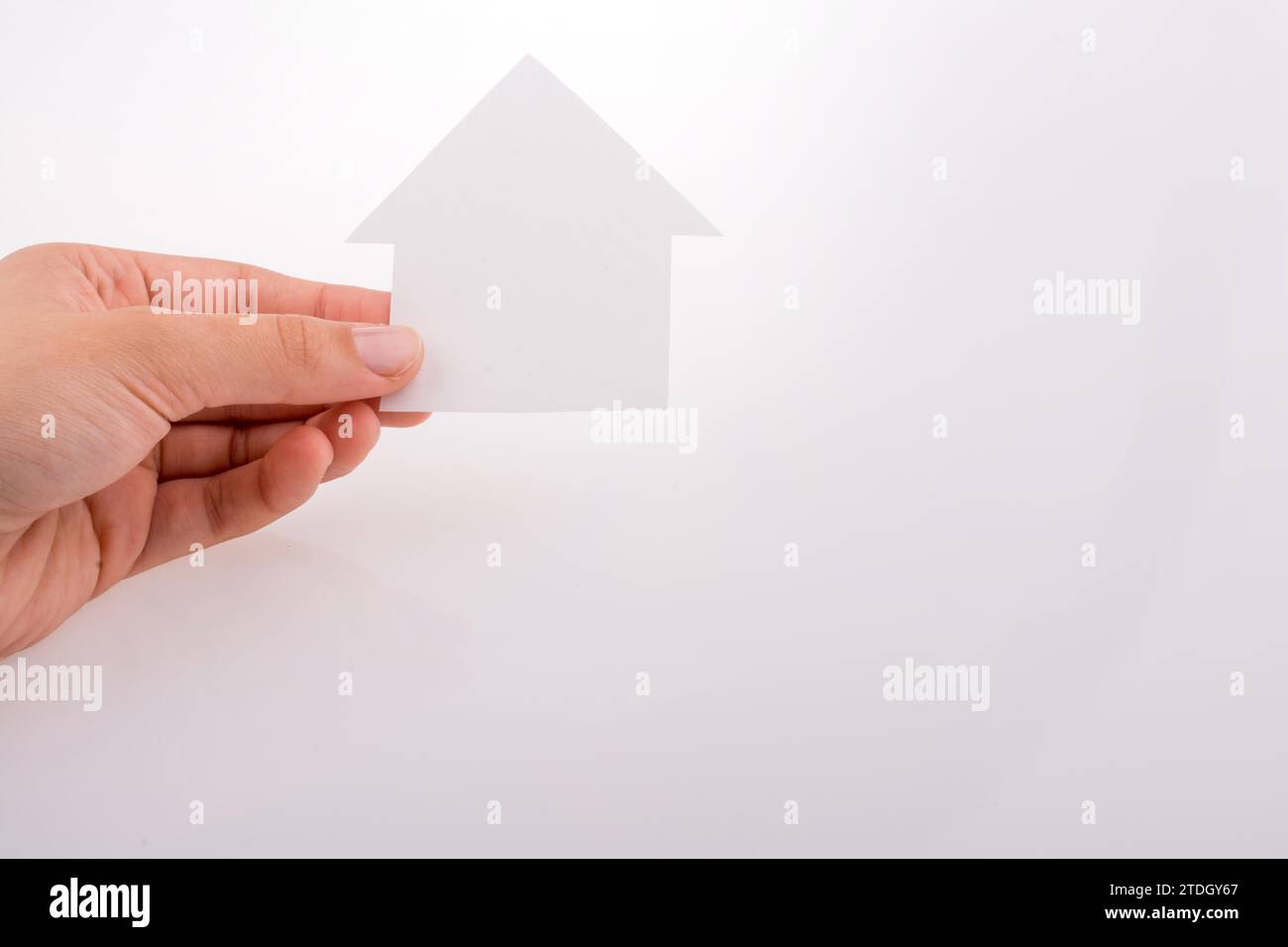 Hand holding a paper house on a white background Stock Photo - Alamy