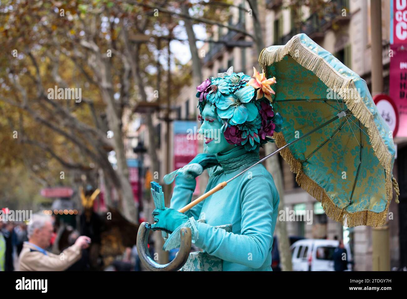 Street performer, mime, living statue of a Dali lady, fantasy figure with parasol and flowers as wig, blue make-up, passers-by, La Rambla, Ramblas Stock Photo