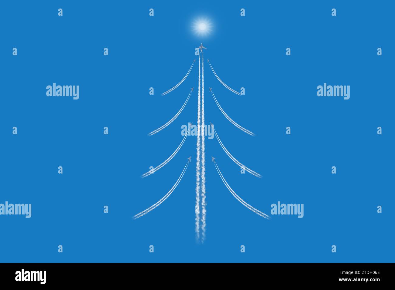 Christmas tree like figure made of airplanes trailes on blue sky  background Stock Photo